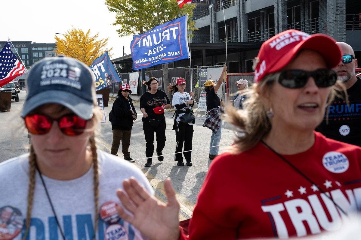 <i>Alex Wroblewski/AFP/Getty Images via CNN Newsource</i><br/>Trump supporters wait for the former president to speak at the Green Bay campaign rally on Wednesday