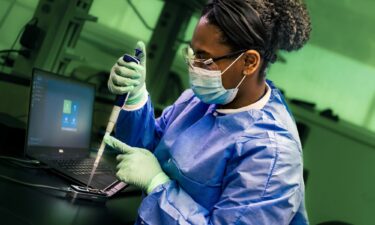 A public health scientist from the CDC's Enteric Diseases Laboratory Branch prepares a portable sequencing instrument for whole genome sequencing