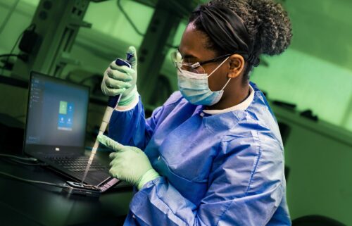 A public health scientist from the CDC's Enteric Diseases Laboratory Branch prepares a portable sequencing instrument for whole genome sequencing