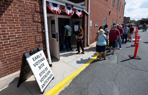 Voters stand in line to cast their ballots on the first day of early voting in Virginia at the Prince William County Office of Elections in Manassas