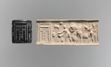 A carved cylinder seal (left)