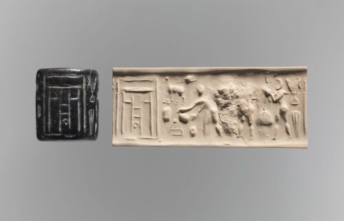 A carved cylinder seal (left)