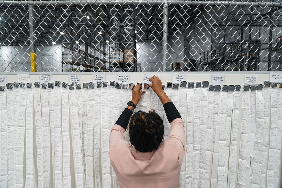 <i>Megan Varner/Getty Images via CNN Newsource</i><br/>Receipts from early voting are being brought out during election night at the Fulton County Elections Hub and Operation Center in Fairburn