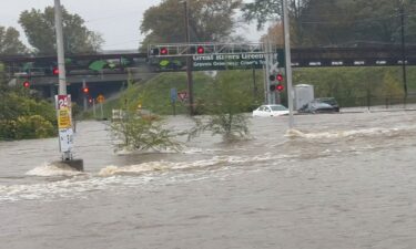 Vehicles are partially submerged by floodwaters caused by heavy rain in St. Louis on Tuesday