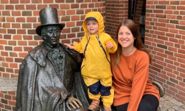 Brooke Black and her daughter pose with a statue of Danish author Hans Christian Andersen in Odense