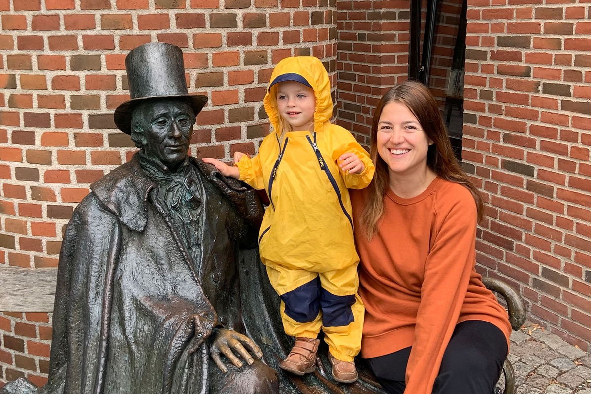 <i>Brooke Black via CNN Newsource</i><br/>Brooke Black and her daughter pose with a statue of Danish author Hans Christian Andersen in Odense