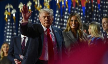 President-elect Donald Trump waves while walking off stage following early results from the 2024 presidential election in Palm Beach County Convention Center