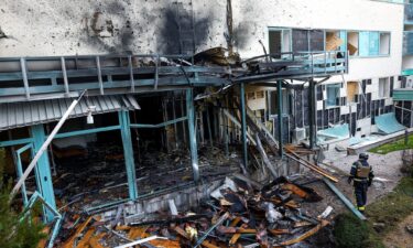 A firefighter responds to damage at a medical center after a Russian drone strike on Kyiv