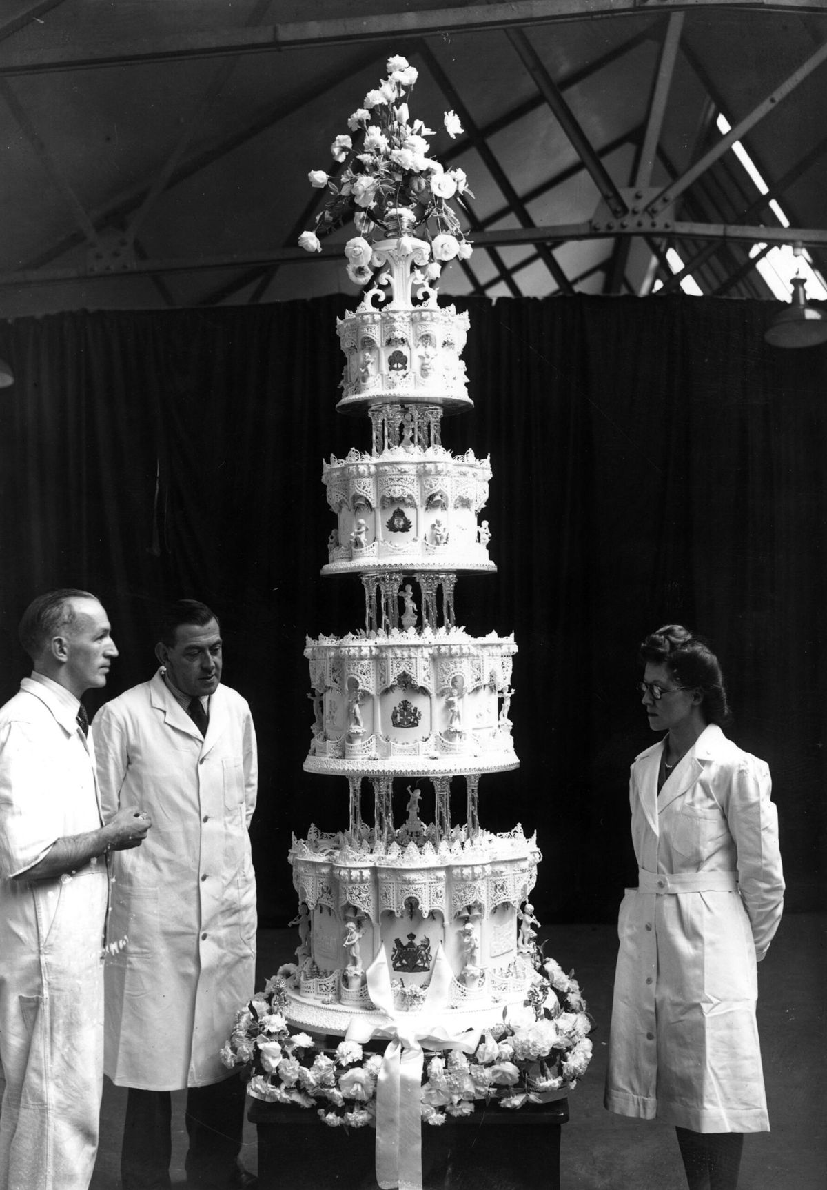 <i>J. A. Hampton/Hulton Royals Collection/Getty Images via CNN Newsource</i><br/>The nine-foot tall cake was made by McVitie and Price Ltd.