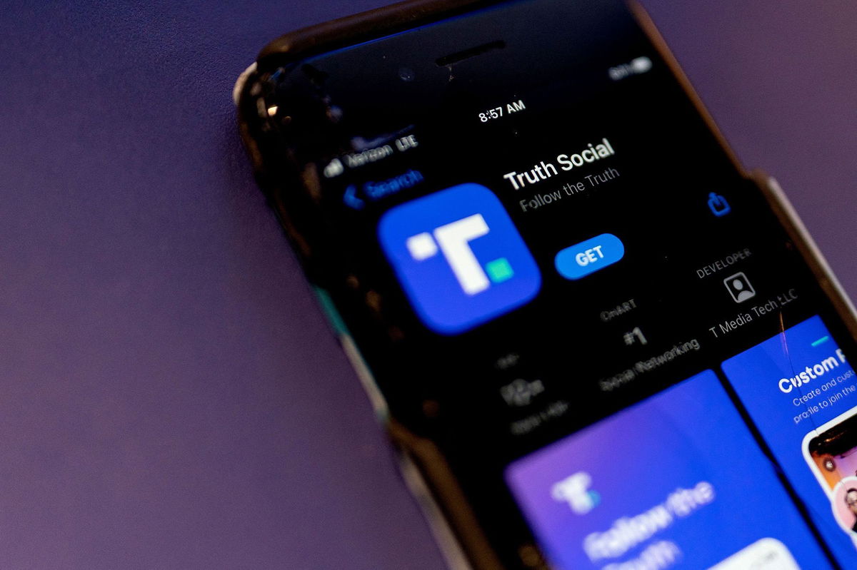 <i>Stefani Reynolds/AFP/Getty Images via CNN Newsource</i><br/>A phone screen displays the Truth Social app in Washington