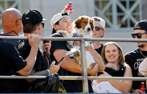 Shohei Ohtani celebrates on the bus with his dog Decoy during the Dodgers' victory parade.