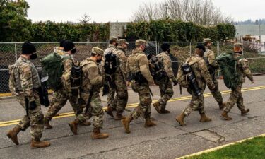 Washington National Guard personnel walk on the Washington State Capitol campus on January 20