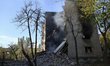 Smoke rises from the debris of a residential building in the town of Lyman