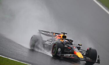 Rain kicks up off the back of Verstappen's car as he competes during the Sao Paulo Grand Prix.