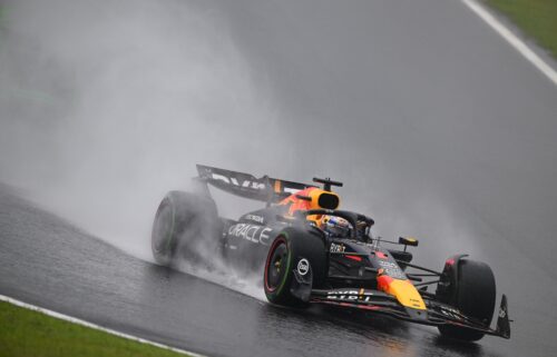 Rain kicks up off the back of Verstappen's car as he competes during the Sao Paulo Grand Prix.