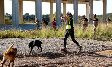 Search and rescue team members look for bodies following flooding in Chiva