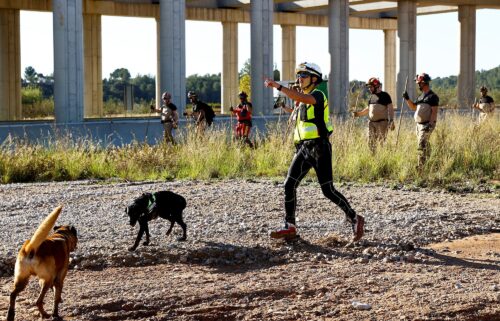 Search and rescue team members look for bodies following flooding in Chiva