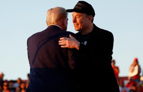 Elon Musk embraces former President Donald Trump during a campaign rally at the Butler Farm Show fairgrounds on October 5 in Butler