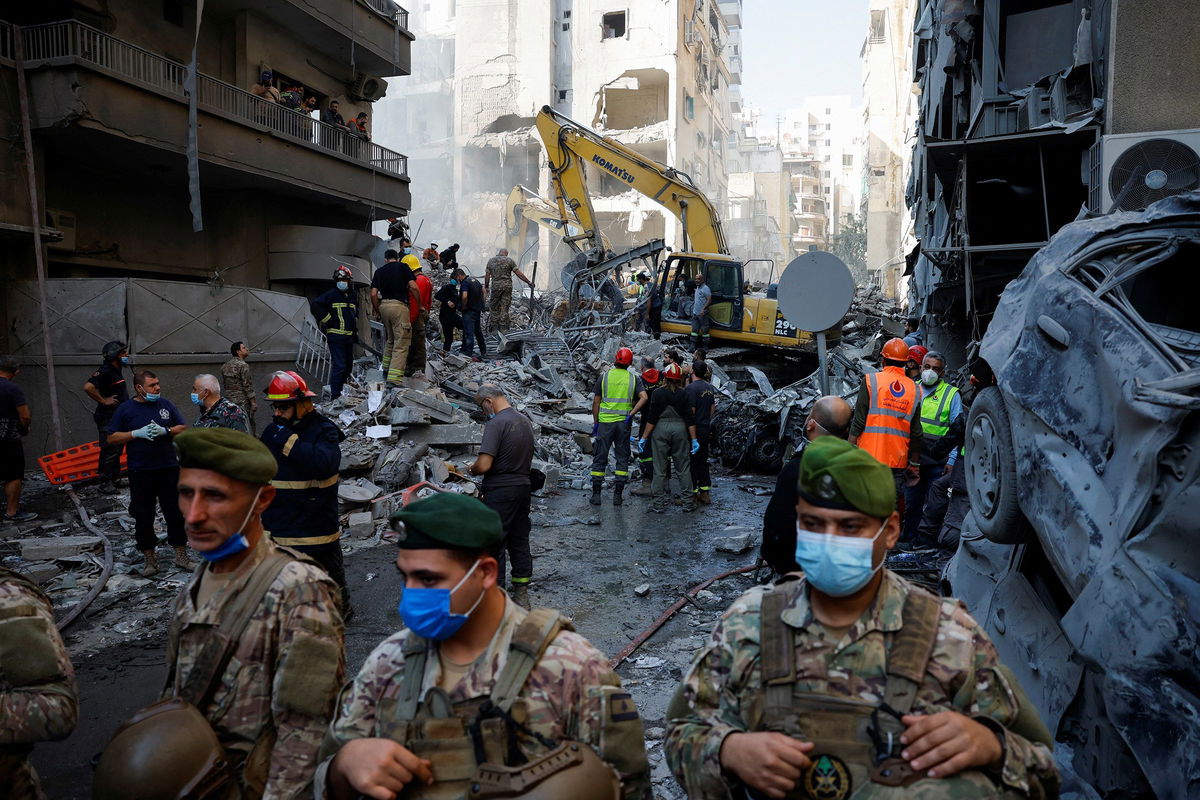 <i>Adnan Abidi/Reuters via CNN Newsource</i><br/>Civil defense members work as Lebanese army soldiers stand guard at the site of an Israeli strike in the Basta neighborhood of Beirut