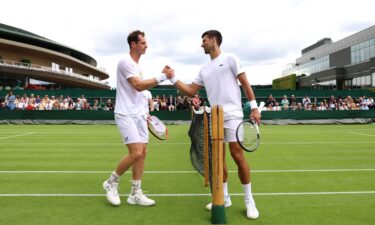 Andy Murray and Novak Djokovic shake hands after a practice session at Wimbledon in 2023.