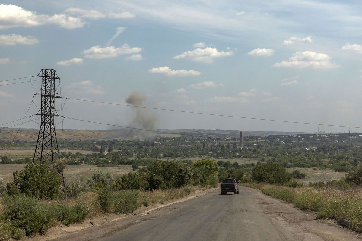 <i>Roman Pilipey/AFP/Getty Images via CNN Newsource</i><br/>A vehicle drives as smoke rises from the town of Siversk