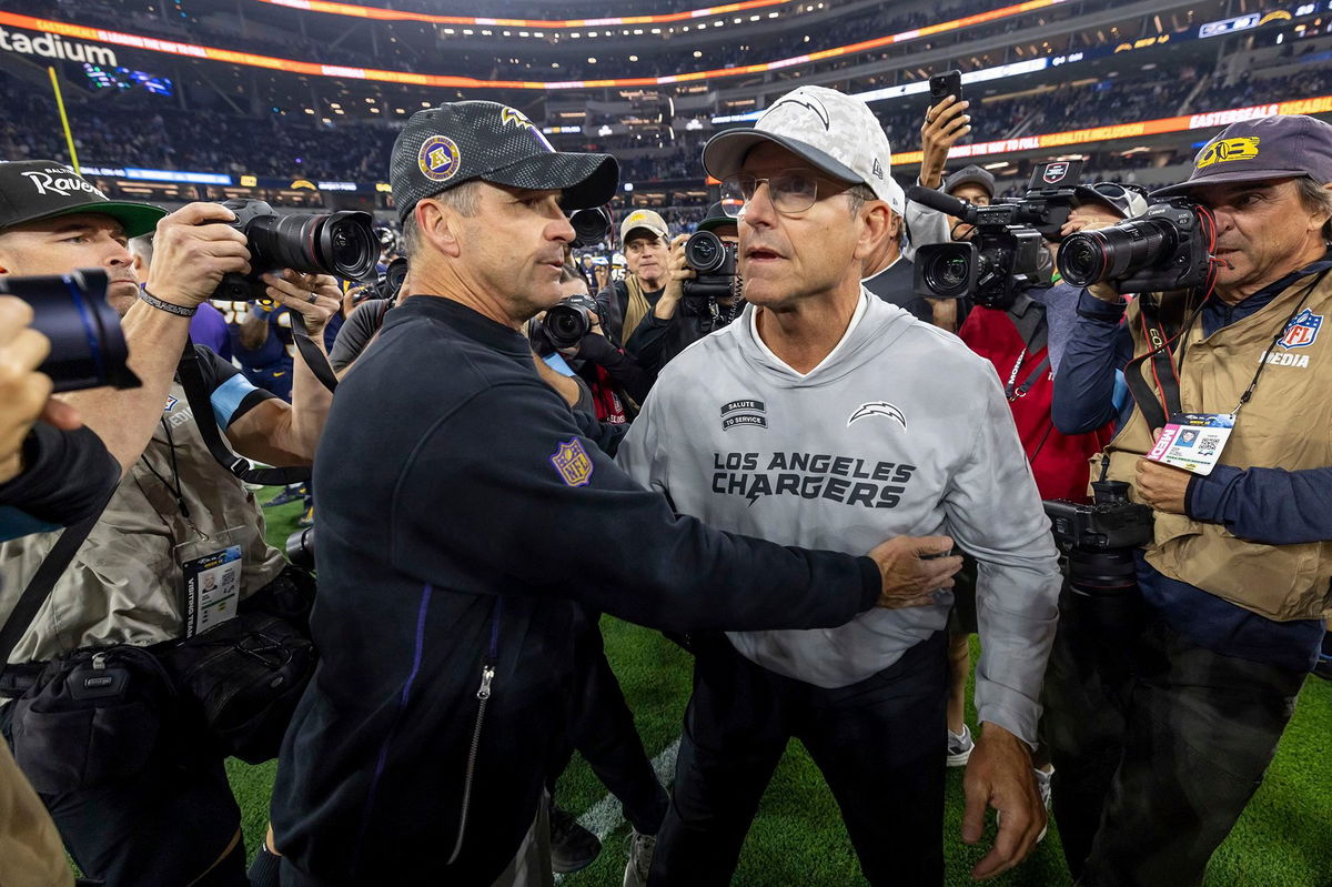 <i>Jeff Lewis/AP via CNN Newsource</i><br/>Baltimore Ravens head coach John Harbaugh (left) hugs his brother