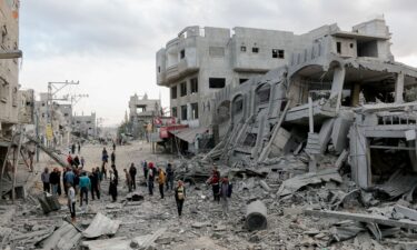 Residents walk through streets of rubble in the Al-Zawaida area of the Gaza Strip on November 1.