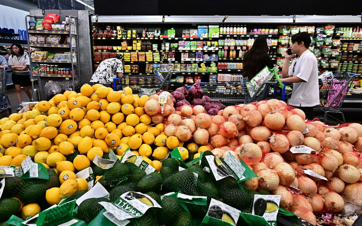 <i>Frederic J. Brown/AFP/Getty Images via CNN Newsource</i><br/>People shop at a grocery store on August 14