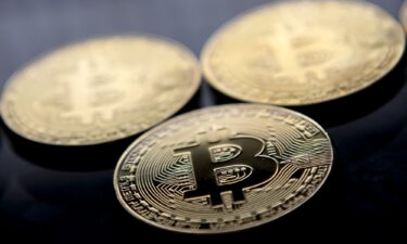 Gold-plated souvenir Bitcoin coins are arranged for a photograph in London in November 2017. Bitcoin hit a new record above $80