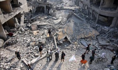 Palestinians check the rubble of the Alloush family's house