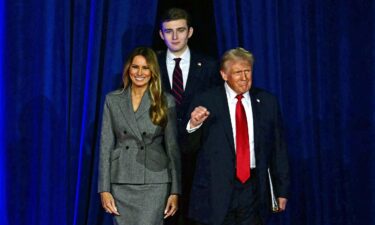 Former President Donald Trump arrives for an election night event alongside former first lady Melania Trump and son Barron Trump in West Palm Beach