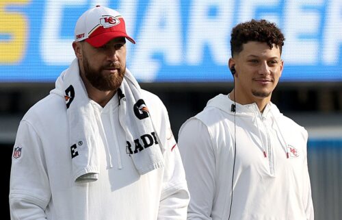 Travis Kelce and Patrick Mahomes of the Kansas City Chiefs look on from the sidelines during a game against the Los Angeles Chargers at SoFi Stadium in Inglewood