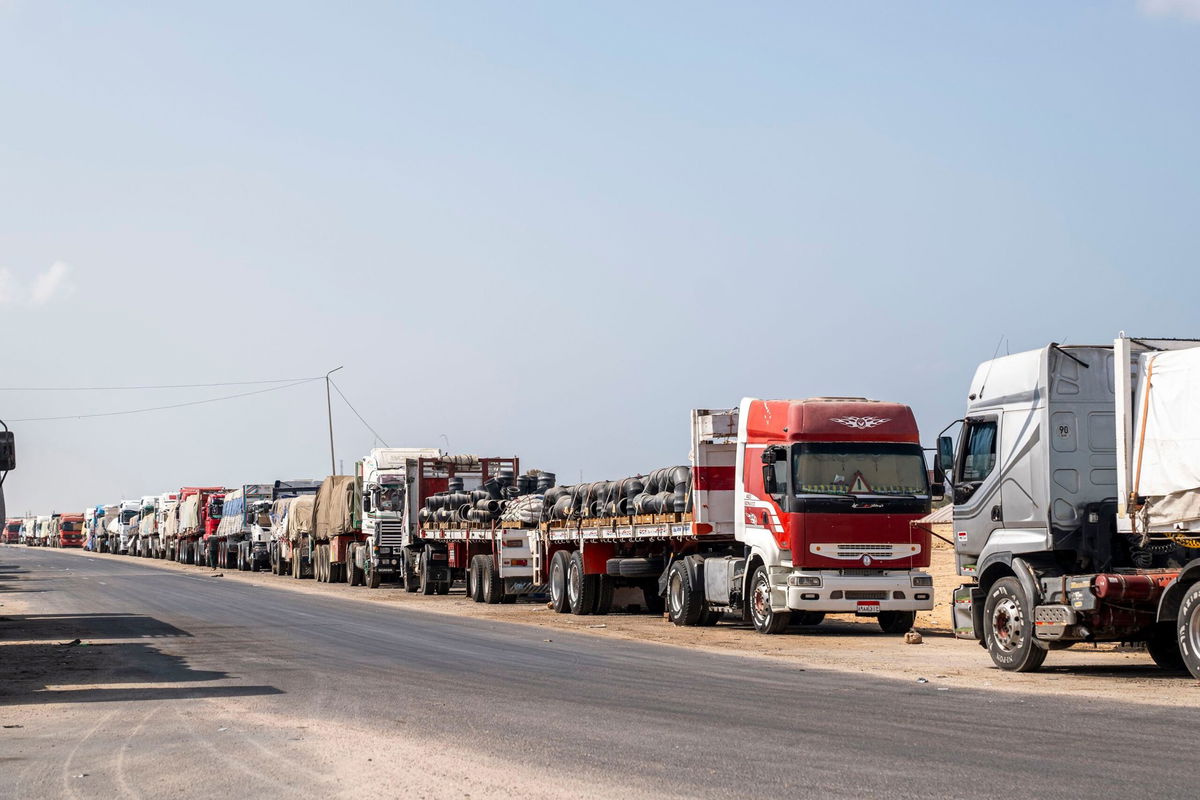 <i>Ali Moustafa/Getty Images via CNN Newsource</i><br/>Trucks with aid destined for the Gaza Strip are parked on the side of the road in Arish