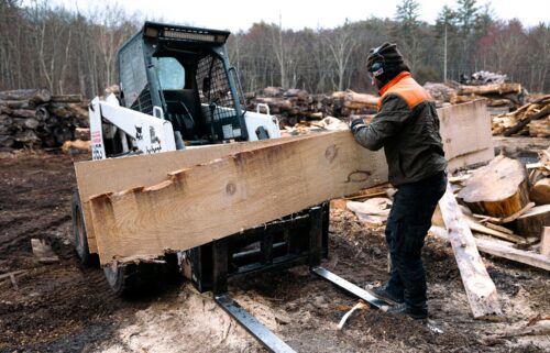 A worker stacks off-cut planks of pine wood on a forklift at Woodstock Wood sawmill in Saugerties