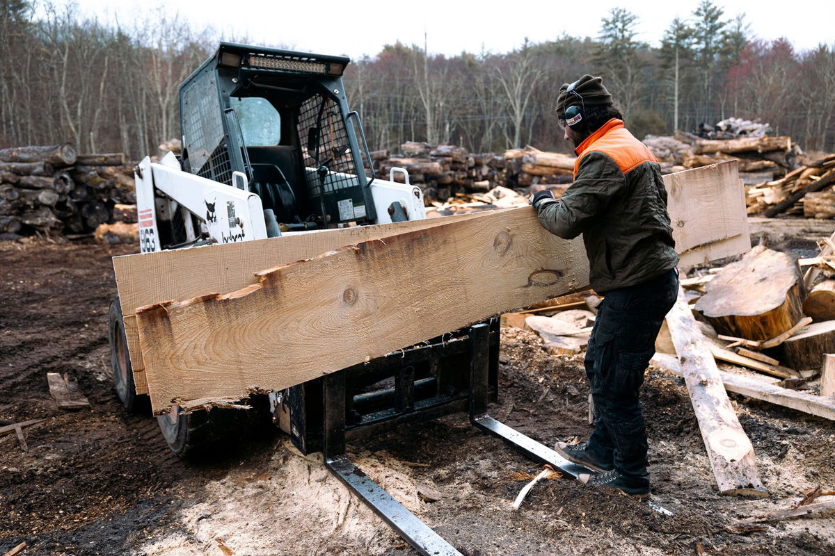 <i>Angus Mordant/Bloomberg/Getty Images/File via CNN Newsource</i><br/>A worker stacks off-cut planks of pine wood on a forklift at Woodstock Wood sawmill in Saugerties