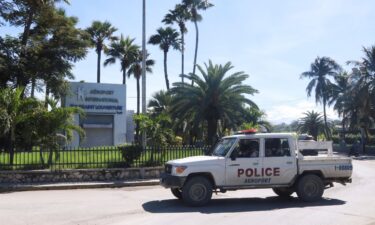 A police vehicle drives outside Toussaint Louverture International Airport in Port-au-Prince