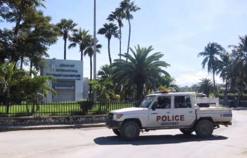 A police vehicle drives outside Toussaint Louverture International Airport in Port-au-Prince