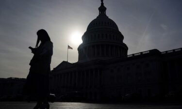 A person uses a mobile phone outside the U.S. Capitol building on Wednesday