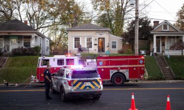 A fire truck and police car on a street in the Clifton neighborhood of Louisville