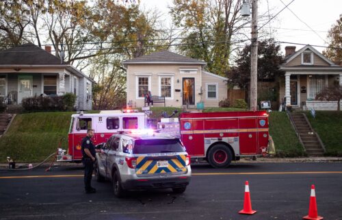 A fire truck and police car on a street in the Clifton neighborhood of Louisville