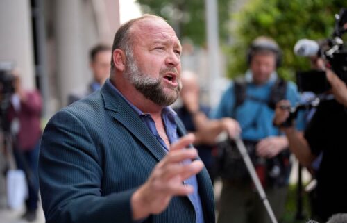 Alex Jones speaks to the media after arriving at the federal courthouse for a hearing in front of a bankruptcy judge