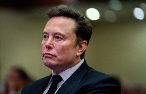 Tesla CEO and X owner Elon Musk listens as US President-elect Donald Trump speaks during a meeting with House Republicans at the Hyatt Regency hotel in Washington