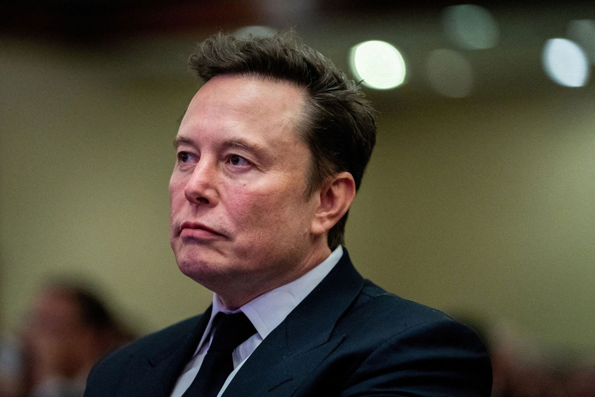 <i>Allison Robbert/Reuters via CNN Newsource</i><br/>Tesla CEO and X owner Elon Musk listens as US President-elect Donald Trump speaks during a meeting with House Republicans at the Hyatt Regency hotel in Washington