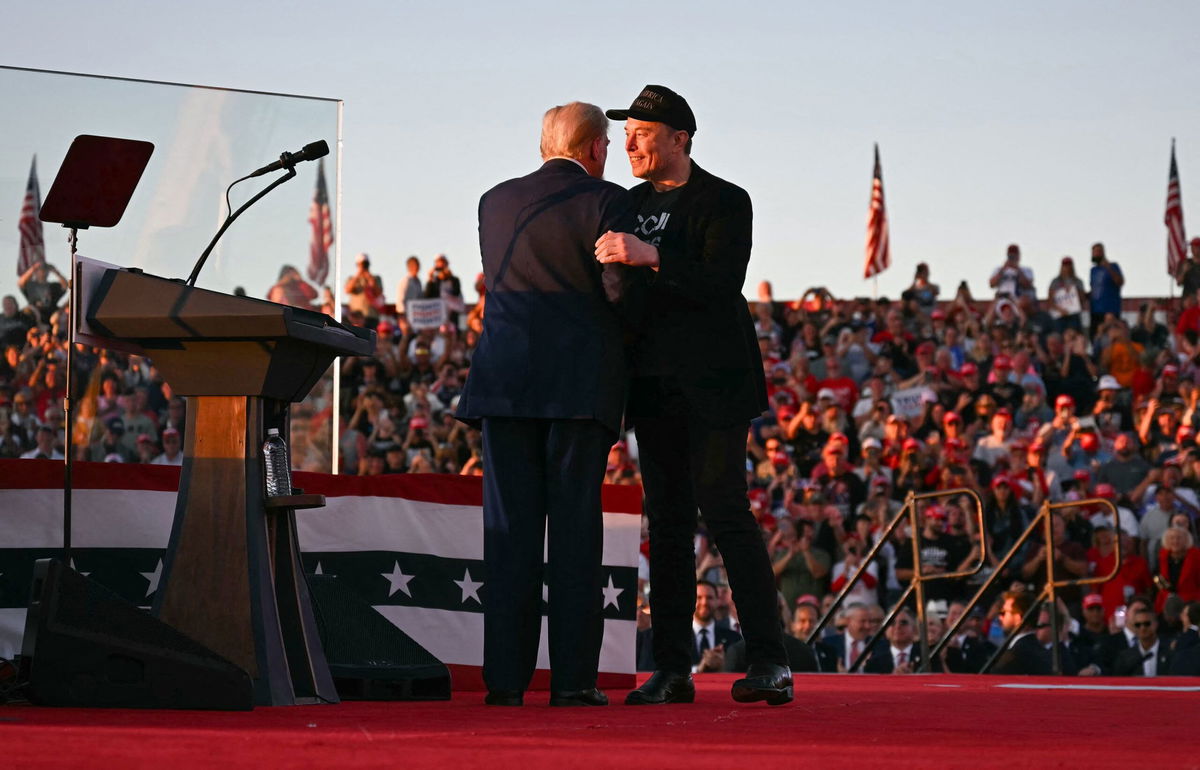 <i>Jim Watson/AFP/Getty Images via CNN Newsource</i><br/>Tesla CEO Elon Musk joins former President and Republican presidential candidate Donald Trump during a campaign rally at the site of his first assassination attempt in Butler