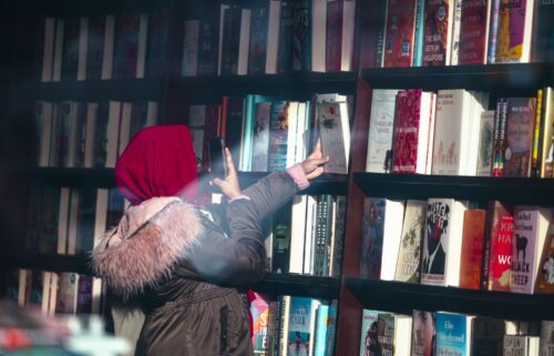 A shopper photographs a book inside a Barnes & Noble bookstore in New York