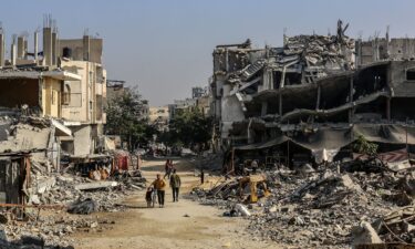 Palestinians are seen among the rubbles of demolished house as Palestinians try to continue their daily lives despite the destroyed buildings and difficult conditions in Khan Yunis