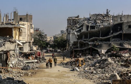 Palestinians are seen among the rubbles of demolished house as Palestinians try to continue their daily lives despite the destroyed buildings and difficult conditions in Khan Yunis