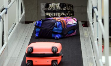 Suitcases roll onto a plane at Dresden International Airport in Germany. Your bags have a better chance of arriving at your destination on time if you come to the departing airport on time.