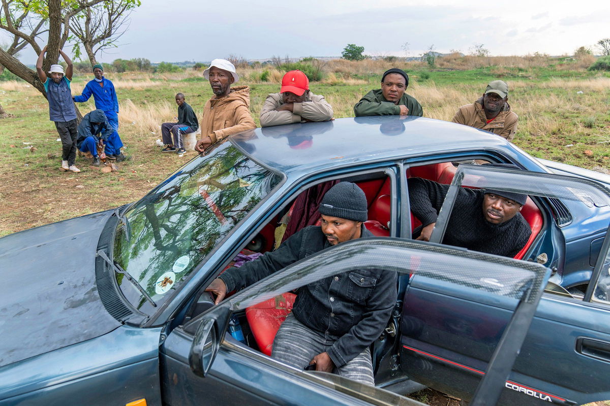 <i>Jerome Delay/AP via CNN Newsource</i><br/>Relatives of miners and community members wait near the shaft of the mine.