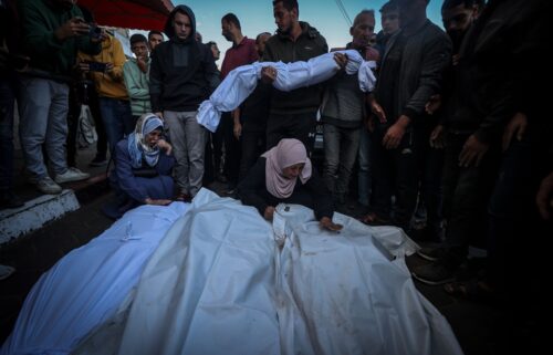 Palestinians mourn near their relatives' funerals after Israeli airstrike hit Bureij Camp in Deir al-Balah